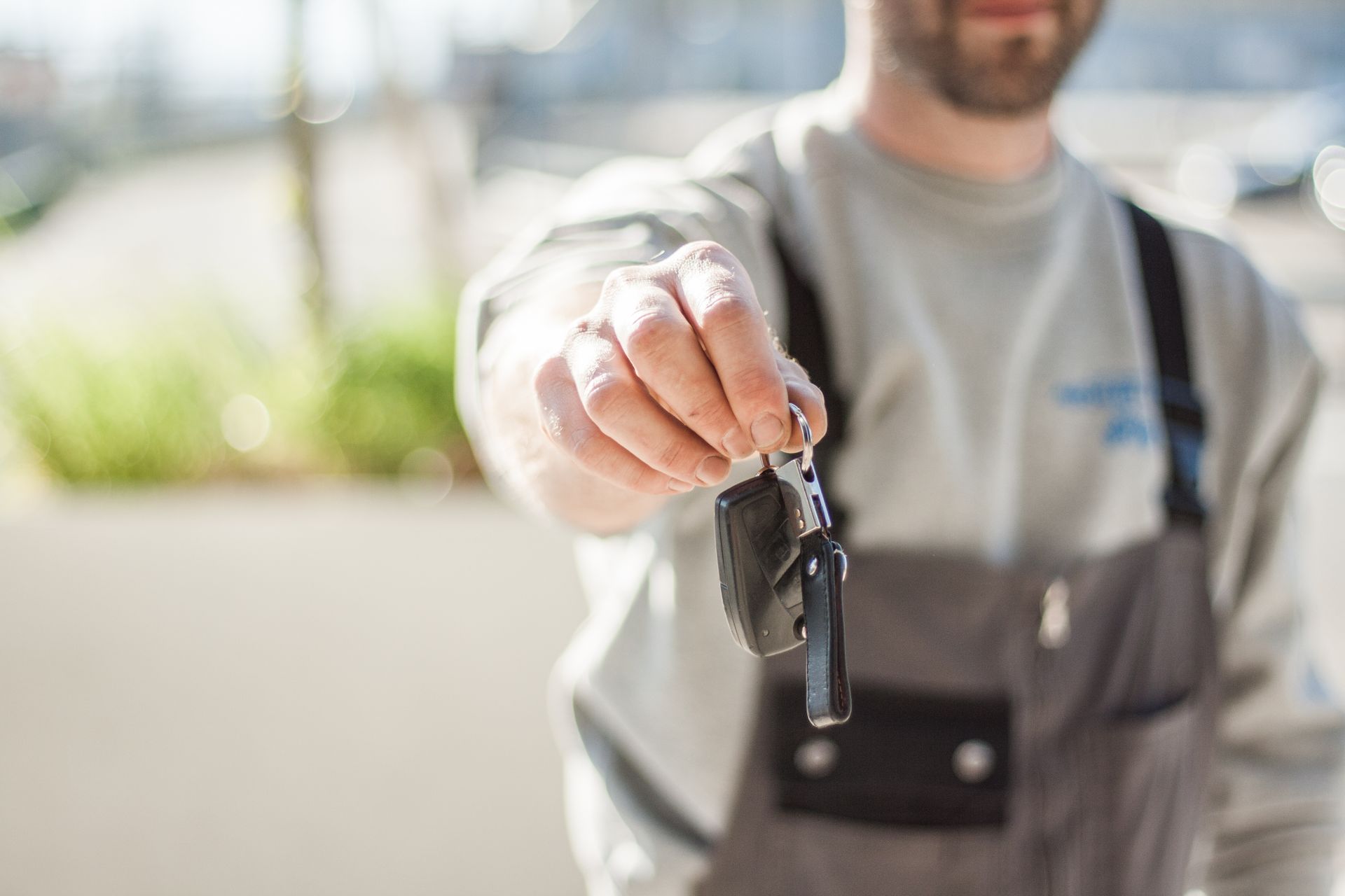 Mobile auto locksmith handing car keys to a customer in Wigan, Liverpool or St Helens